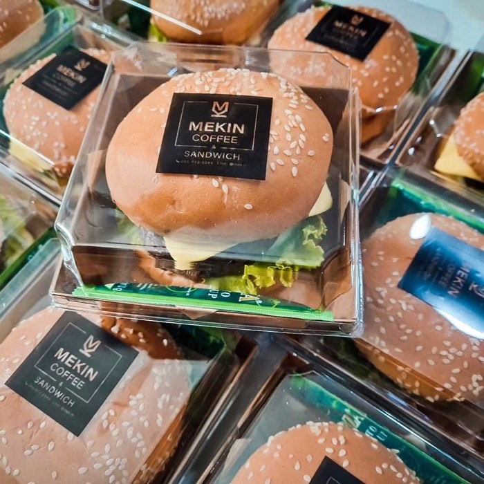 Mekin burger packed in a clear box with lettuce and cheese