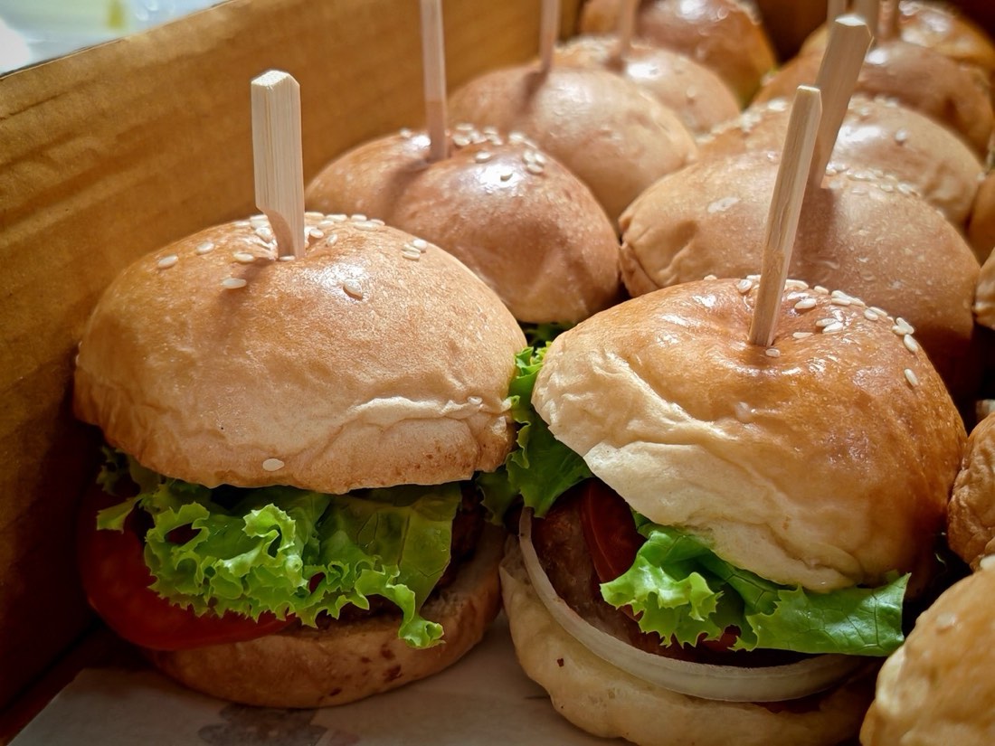 Trays of Mekin slider sandwiches ready for a large event